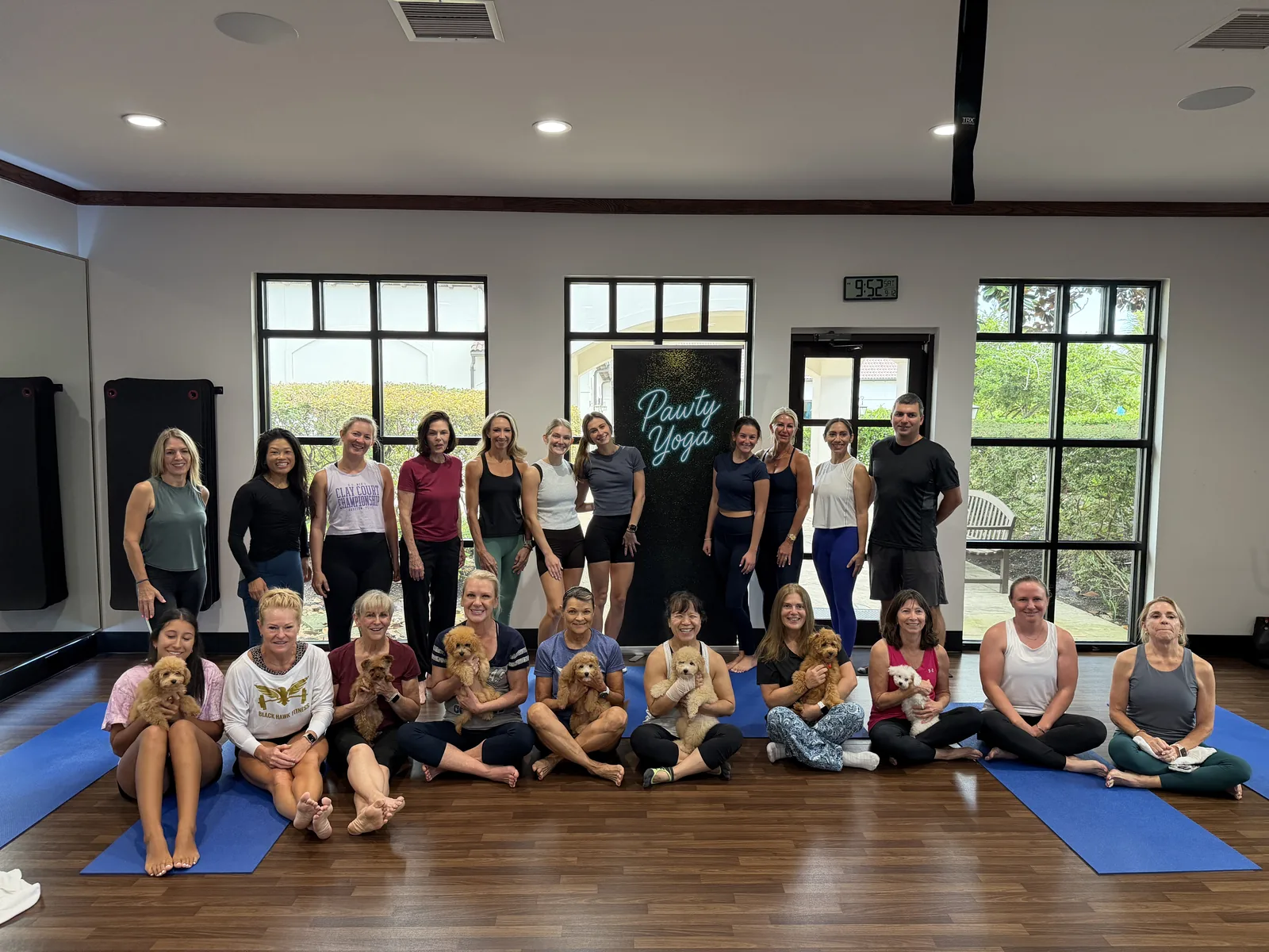 A private group with puppies and the Pawty Yoga banner at a Houston club venue we traveled to