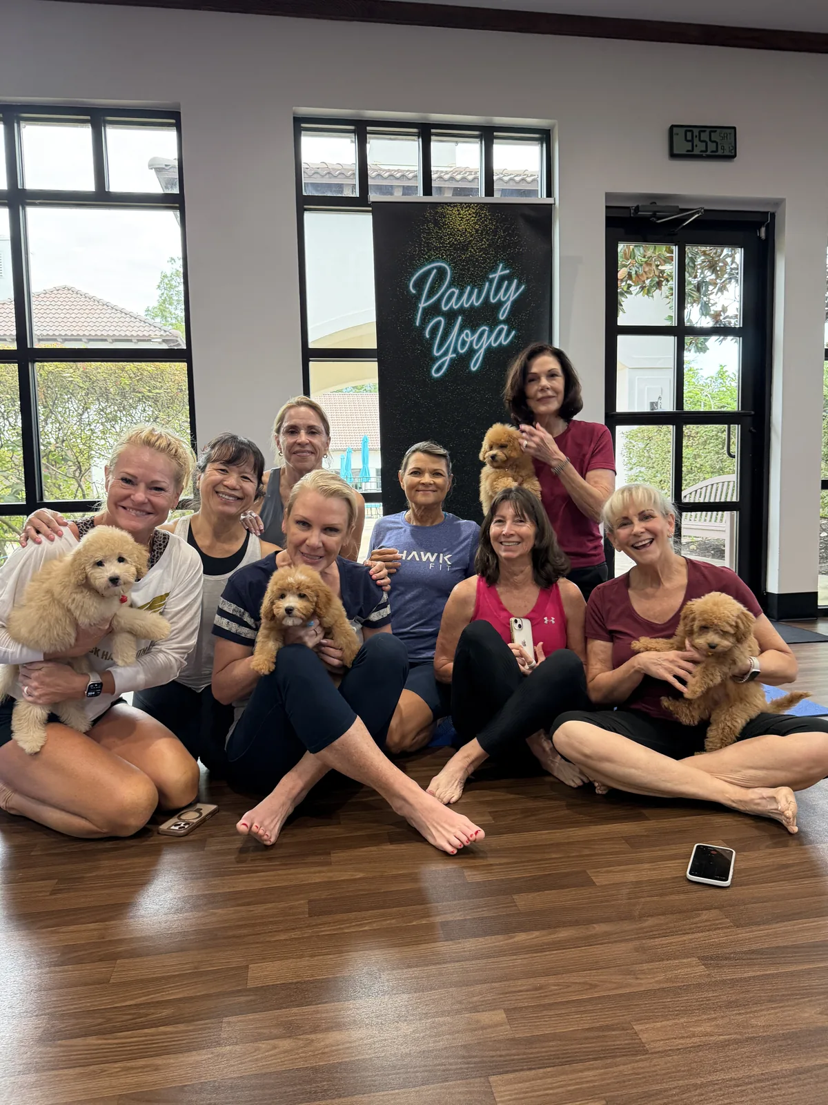 Adults holding puppies by tall windows at a Houston evening session, a relaxed date idea